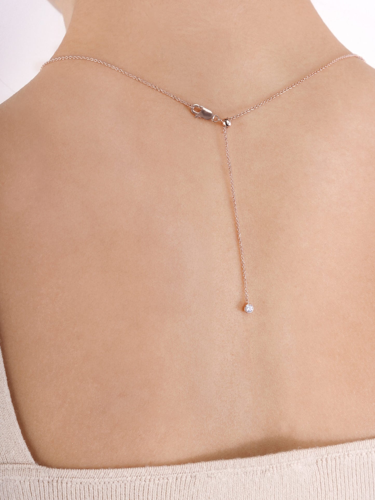 Mondays Made's necklace chain in 18k rose gold vermeil is easily adjustable to different lengths, with a moissanite adding a touch of sparkle at the end.