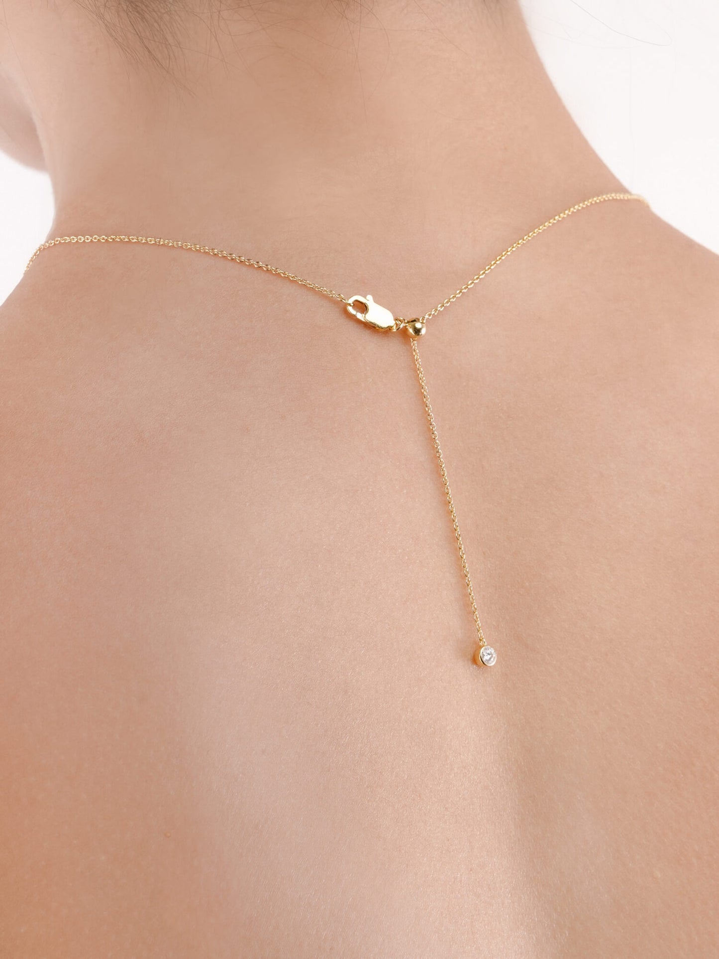 Mondays Made's necklace chain in 18k gold vermeil is easily adjustable to different lengths, with a moissanite adding a touch of sparkle at the end.