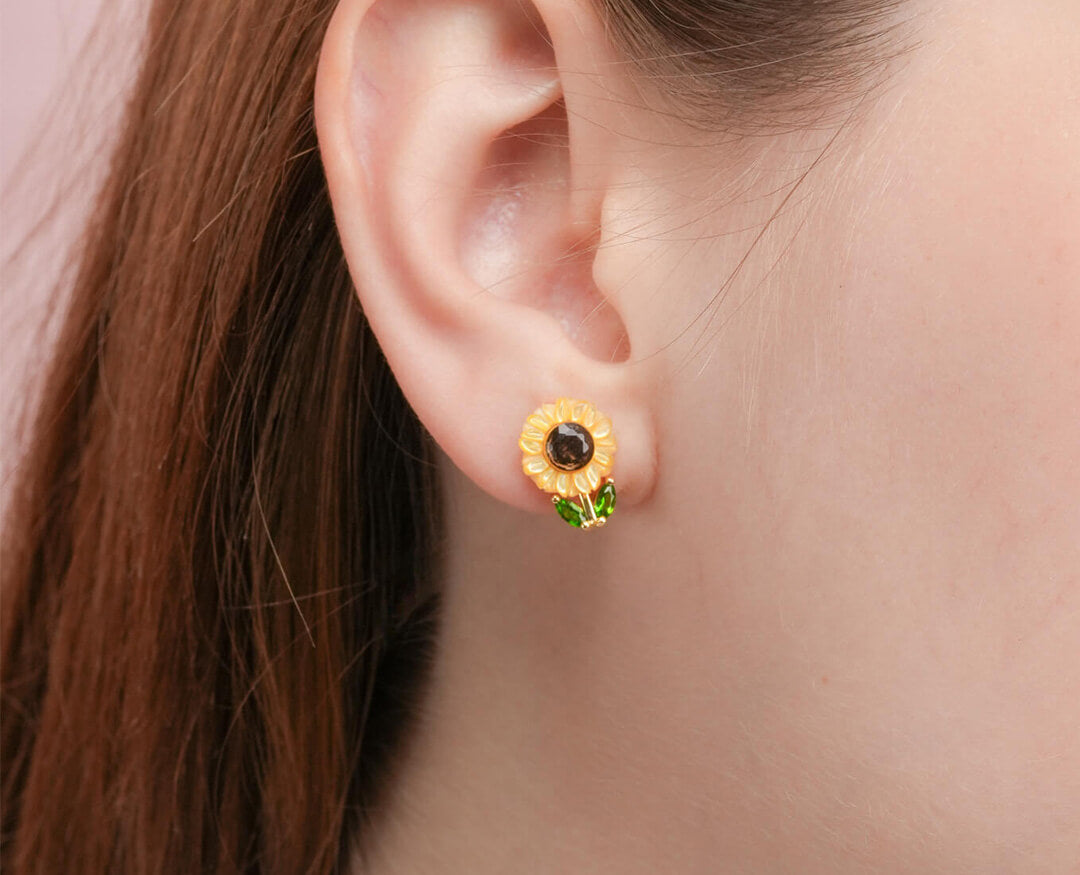 Close up of Mondays Made's Carved Sunflower Stud Earrings in 18k Gold Vermeil worn on a model